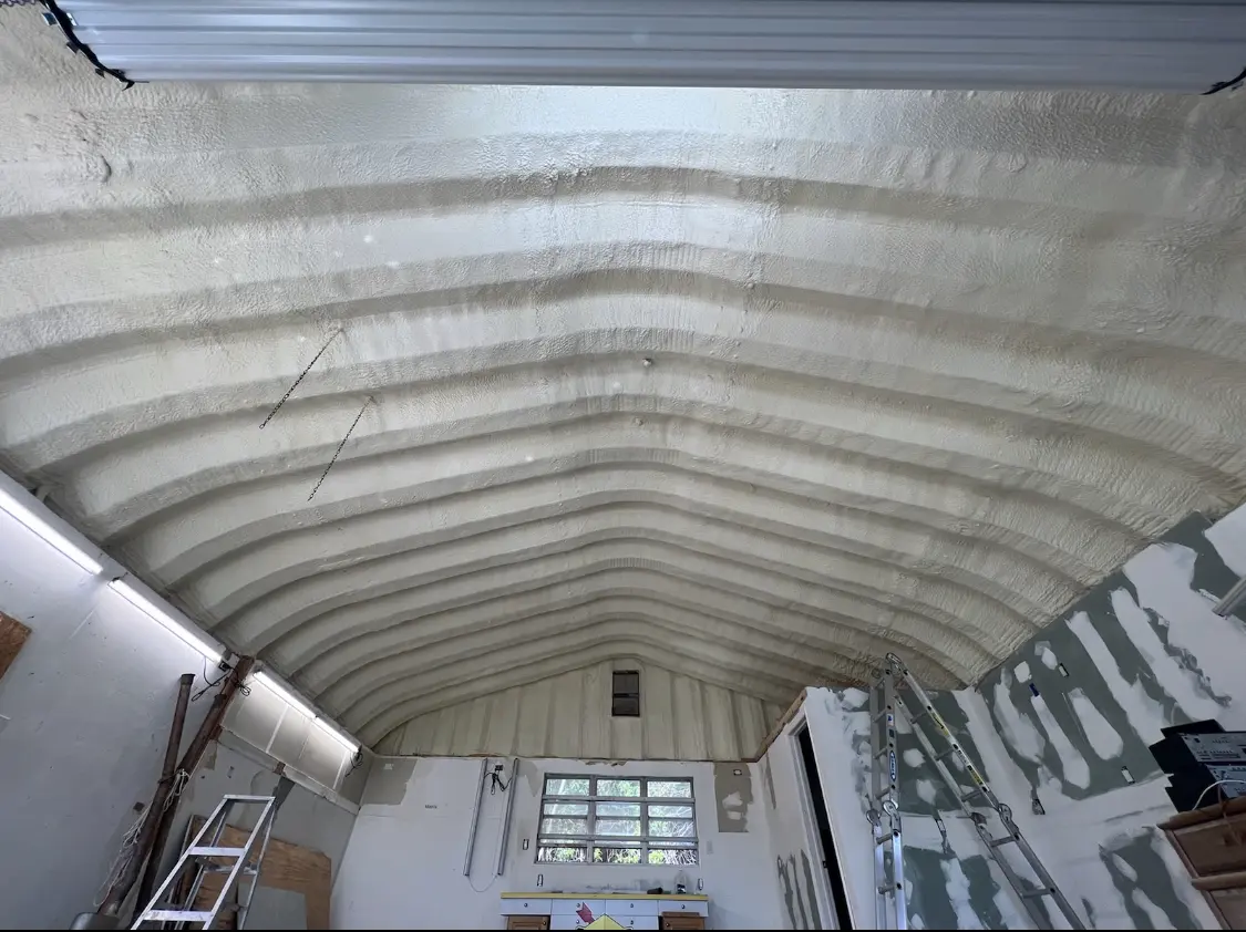 Spray polyurethane foam applied to the underside of a metal roof deck in Genesee